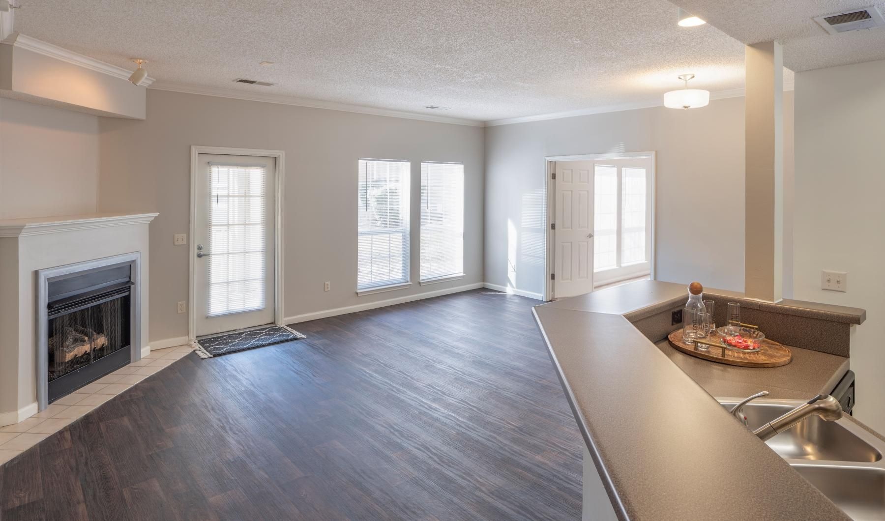 Generous living spaces to relax and unwind a living room with wood floors and a fireplace